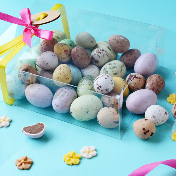 Clear box filled with pastel coloured Easter eggs