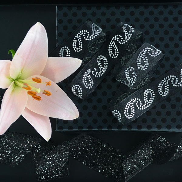 Gift wrapped in black dotted paper, with diamante and glitter black ribbons