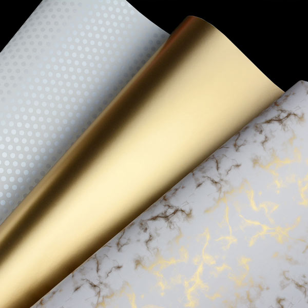 A mix of 3 gift wraps in white and metallic gold