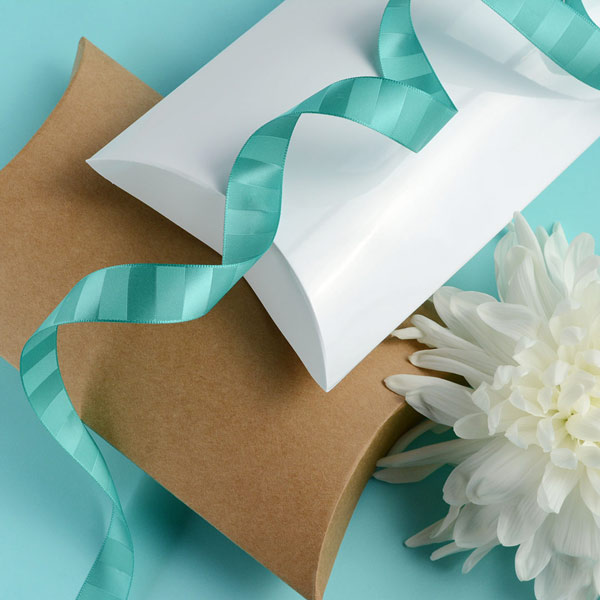 Kraft and white gloss pillow boxes, with 18mm woven satin ribbon in aquamarine