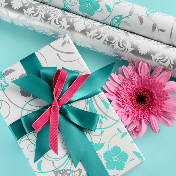 Wrapped gift in jade-silver wrap, with jade 25mm satin ribbon and hot pink 10mm woven ribbon